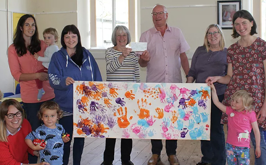 phil blease receiving a poster from the toddlers