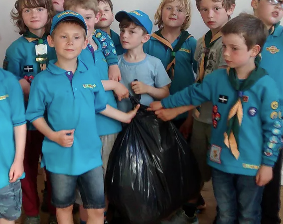 Brownies holding a bin bag